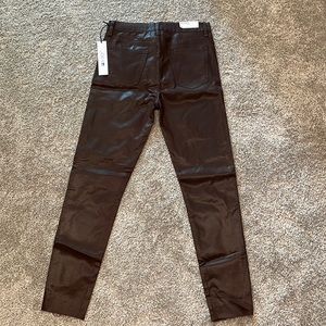 Faux leather dark burgundy/chocolate high rise ankle pants with a raw hem.
